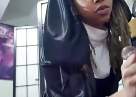 Ebony gal in a nun cosplay gives a stud a blowjob indoors