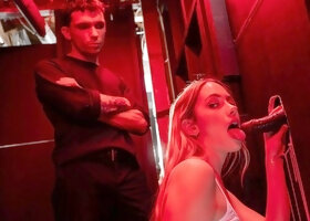 Khloe Kapri kneels for gloryhole oral under red club lights